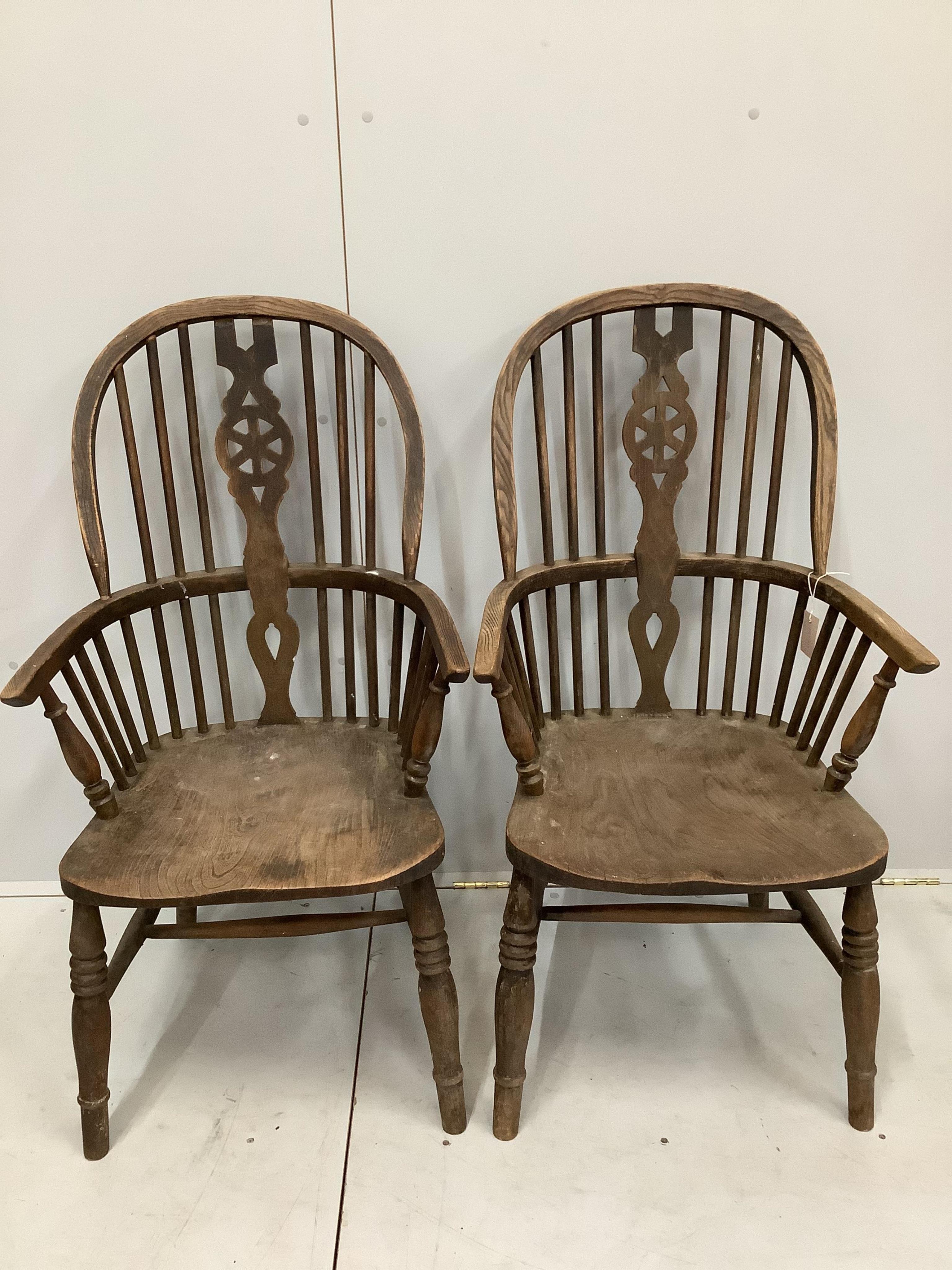 A pair of ash and elm Windsor wheel back armchairs, width 58cm, depth 48cm, height 112cm